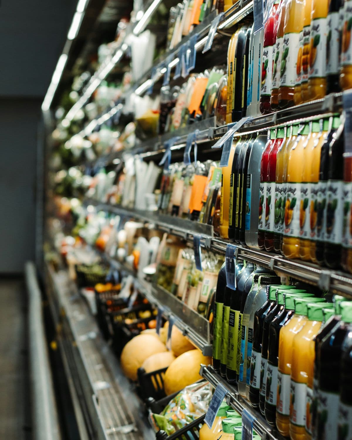 Grocery aisle shelves stocked with bottled drinks